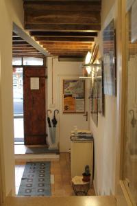 a hallway of a restaurant with a door and a table at Alter Ego b&b Assisi in Assisi