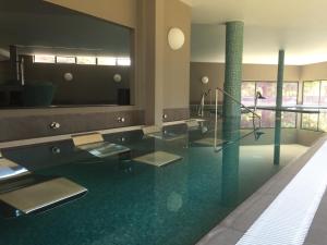 a lobby with a glass floor in a building at Hotel Bienestar Termas De Vizela in Vizela