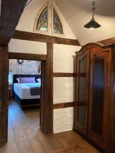 a bedroom with a bed and a wooden cabinet at Historisches Tagelöhnerhaus in Geisingen