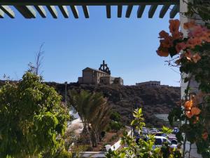 a view from the window of a house with a church on the hill at La Casa del Sol, Abades in Abades