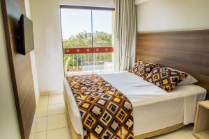 a bedroom with a bed with a large window at Barretos Country Park & Resort in Barretos +84 photos