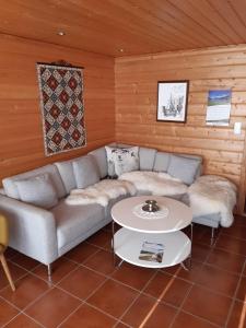 a living room with a couch and a table at Hus med sjøutsikt in Frafjord