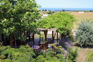 a garden with a table and chairs and trees at Vis Velika in Velika