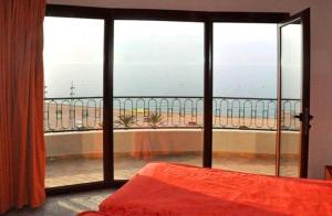 a bedroom with a view of the ocean from a balcony at Hotel Haromar in Calella