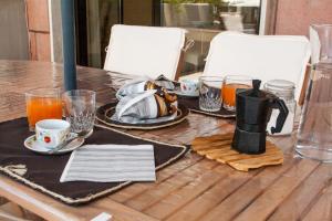 a table with plates and cups and drinks on it at A 20 mt dal mare in Gallipoli +47 photos