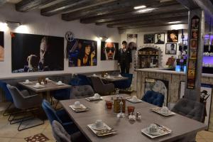 a restaurant with tables and chairs and posters on the walls at Hotel Karthäuser Hof in Flörsheim