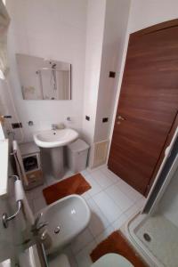 a bathroom with a sink and a toilet and a door at A 20 mt dal mare in Gallipoli