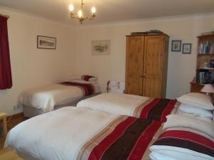 A bed or beds in a room at Trewan Holiday Cottage 