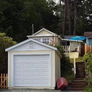 a white garage door in front of a house at Happy Crabby Shack in Rockaway Beach