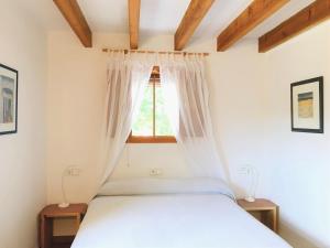 a bedroom with a bed and a window at Ses Oliveres in Cala Saona +27 photos