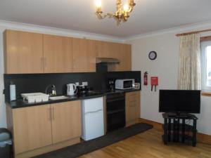 A kitchen or kitchenette at Trewan Holiday Cottage 