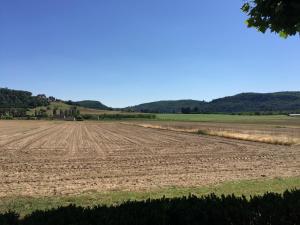 an open field with a field of dirt at Le Relais des 5 Chateaux in Vézac