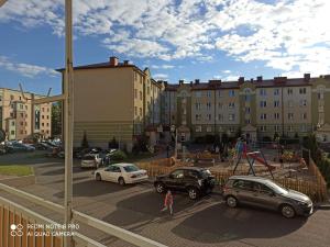 a view of a parking lot with cars and buildings at APARTAMENT RELAX in Ełk