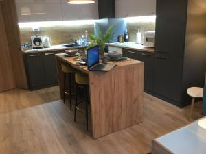 a kitchen with a island with a laptop on it at Your Place Apartment in Varna City