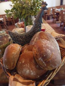 a basket of loaves of bread on a table at Hotel a Hostinec Tálský mlýn in Žďár nad Sázavou