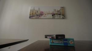a stack of disks on a table in front of a painting at Family Hostel Lviv in Lviv