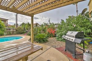 a backyard with a grill and a swimming pool at South Padre Island Oasis with Pool Walk to Beach! in South Padre Island