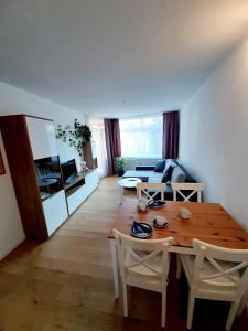 a living room with a wooden table and a couch at Apartment Anja in Schluchsee