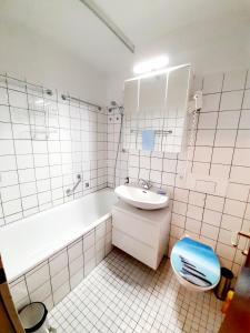 a bathroom with a sink and a tub and a toilet at Apartment Anja in Schluchsee