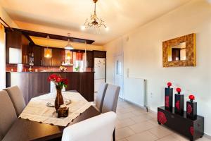 a dining room and kitchen with a table and chairs at Jasmine in Preveza
