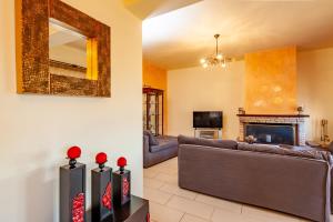 a living room with a couch and a fireplace at Jasmine in Preveza