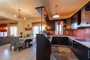 a kitchen with a table and a dining room at Jasmine in Preveza +10 photos