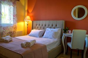 a bedroom with a bed with towels on a table at Jasmine in Preveza