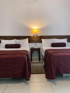 Postel nebo postele na pokoji v ubytování HOTEL MI SOLAR EJECUTIVO