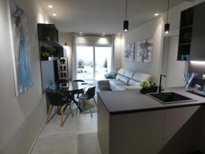a kitchen and living room with a couch and a table at Town-Beach Home in Civitanova Marche