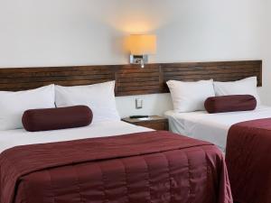 Postel nebo postele na pokoji v ubytování HOTEL MI SOLAR EJECUTIVO