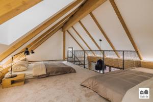 ein Schlafzimmer im Dachgeschoss mit zwei Betten und einem Balkon in der Unterkunft Resort Lednice - Eisgrub in Lednice + 114 Fotos