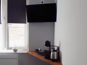 a kitchen with black cabinets and a counter top at La Cour in Charleville-Mézières