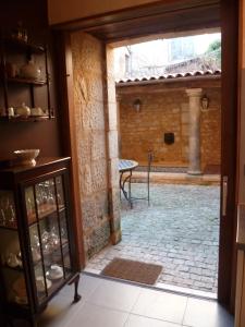 an open door to a courtyard with a patio at Appartement Le Cardinal in Sarlat-la-Canéda