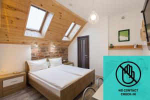 a bedroom with a bed and a sign that says no contact catalyst inn at 7 Apartments in Lviv