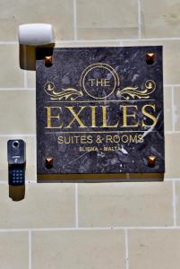 a sign for thees suites and rooms on a wall at The Exiles Hotel in Sliema