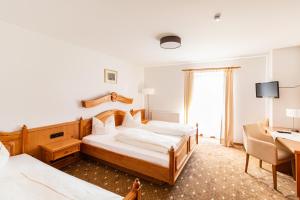 Postel nebo postele na pokoji v ubytování Hotel Gasthof Neuwirt