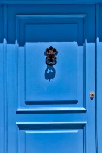 a blue door with a door knob on it at The Exiles Hotel in Sliema