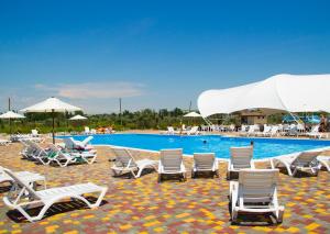 a group of lounge chairs and a swimming pool at Променад "MAXXSEA" in Zatoka +20 photos