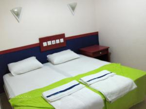 Un pat sau paturi într-o cameră la Odessa Otel Avsallar