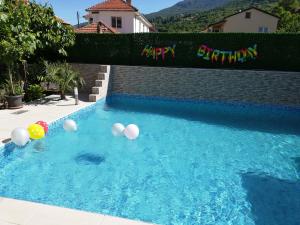 a pool with a bunch of balloons in the water at Lile Pestani Accommodation in Peštani