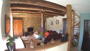 a living room with a table with flowers on it at Gîte de La Pilotais in Pleslin-Trigavou