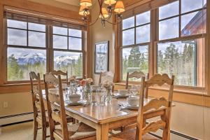 a dining room with a table and chairs and windows at Keystone Condo on Golf Course with Mountain View in Keystone