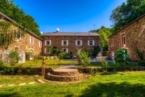 an old brick house with a garden in front of it at La Bastide d'Albignac in Le Dourn