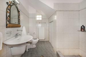 a white bathroom with a sink and a toilet at Danai House in Nea Roda +14 photos