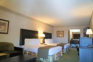 a hotel room with two beds and a desk at College Inn in Monmouth