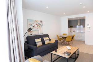 a living room with a couch and a table at CONCHEIROS 5 APARTAMENTOS TURISTICOS in Santiago de Compostela