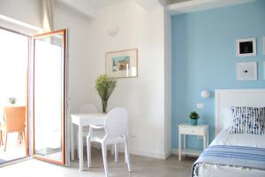 um quarto com uma cama, uma mesa e um espelho em Casa Peonia em Tropea