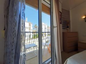 a bedroom with a view of a balcony at Apartamento Orange in Denia