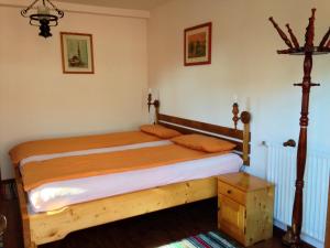 a bedroom with a wooden bed in a room at Cabana Bavaria in Sovata