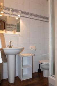 a bathroom with a sink and a toilet at Hôtel de la Mairie in LʼArgentière-la-Bessée